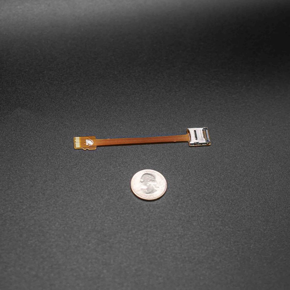 TF Card extension cable's size compared to a quarter dollar